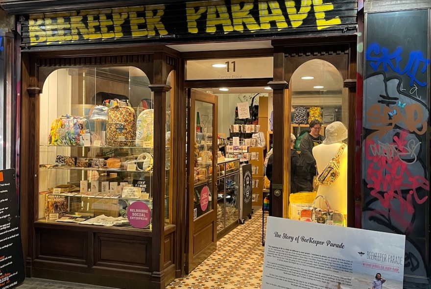 Beekeeper Parade shop exterior with signage and heritage windows with wooden frames, tiled floor leading into the store.