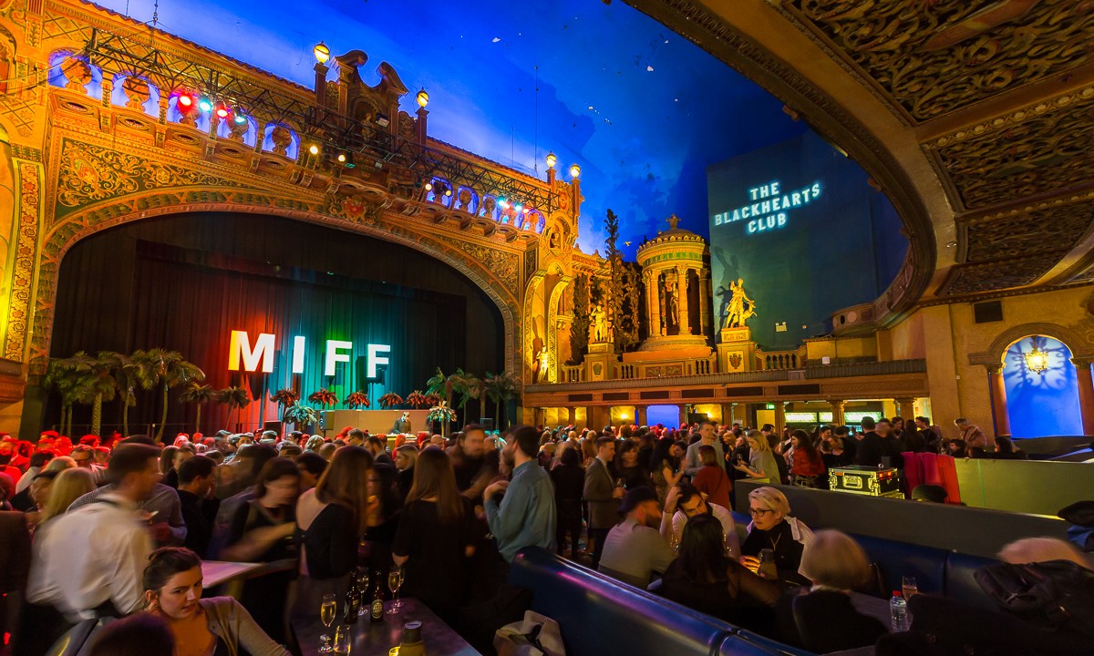 A crowd of people mingling inside Forum Melbourne. 