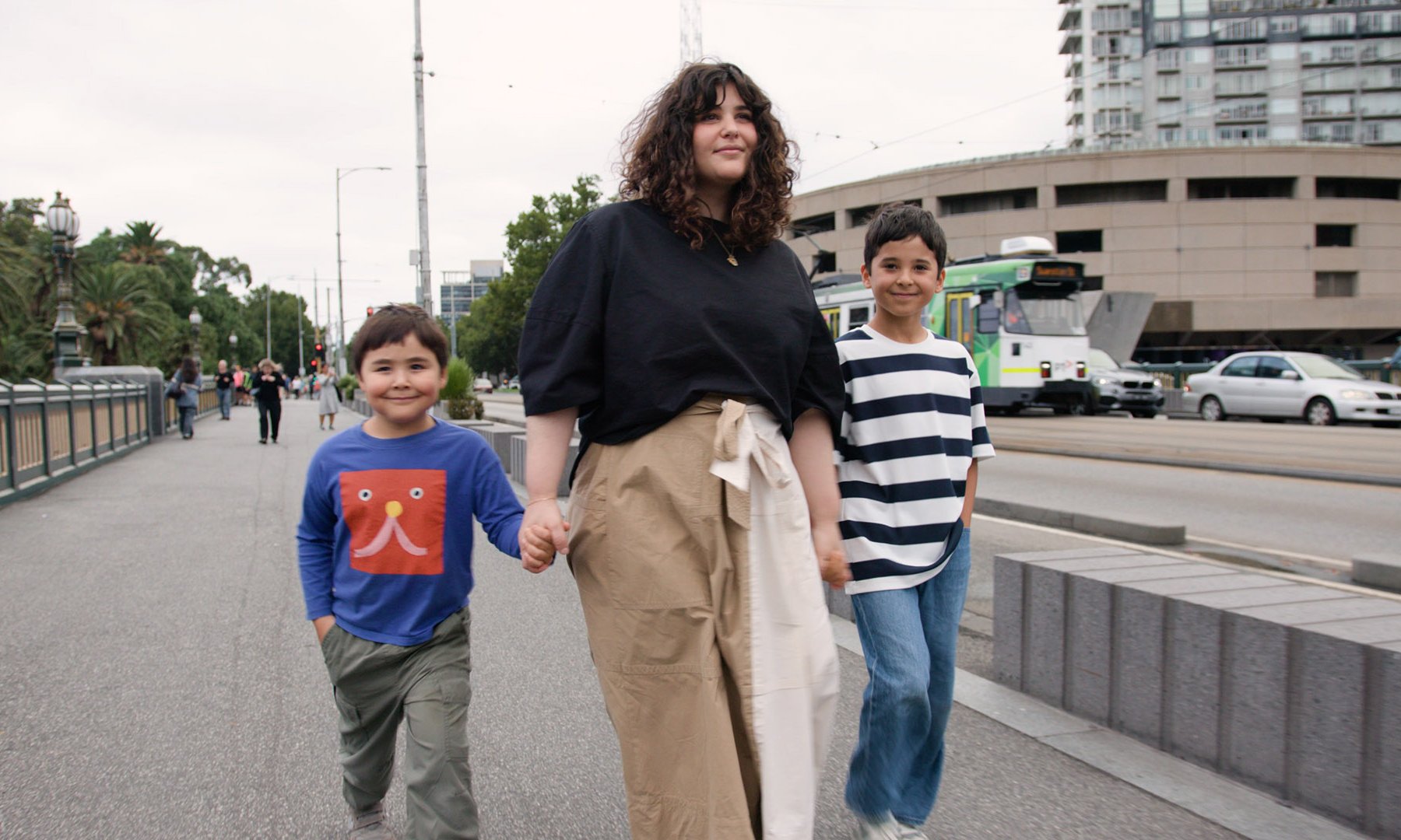 Julia and her two kids walking across Princes Bridge