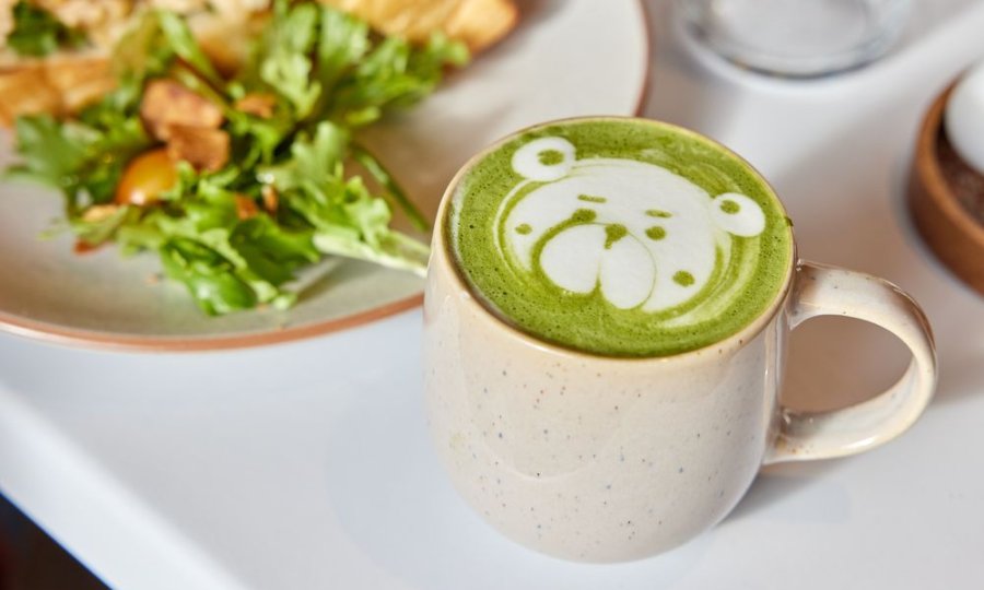 A green tea latte with latte art