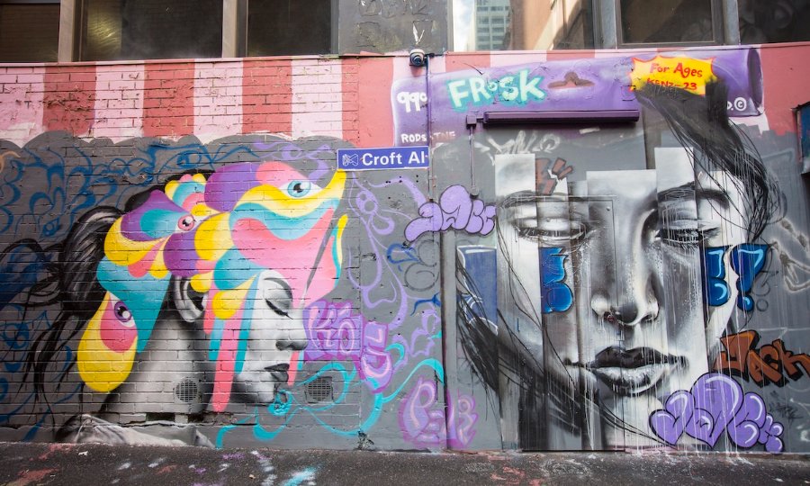 Street art mural featuring women's faces.