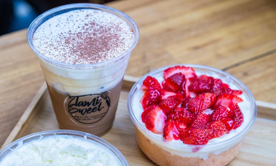 Image of creamy drink next to a strawberry dessert