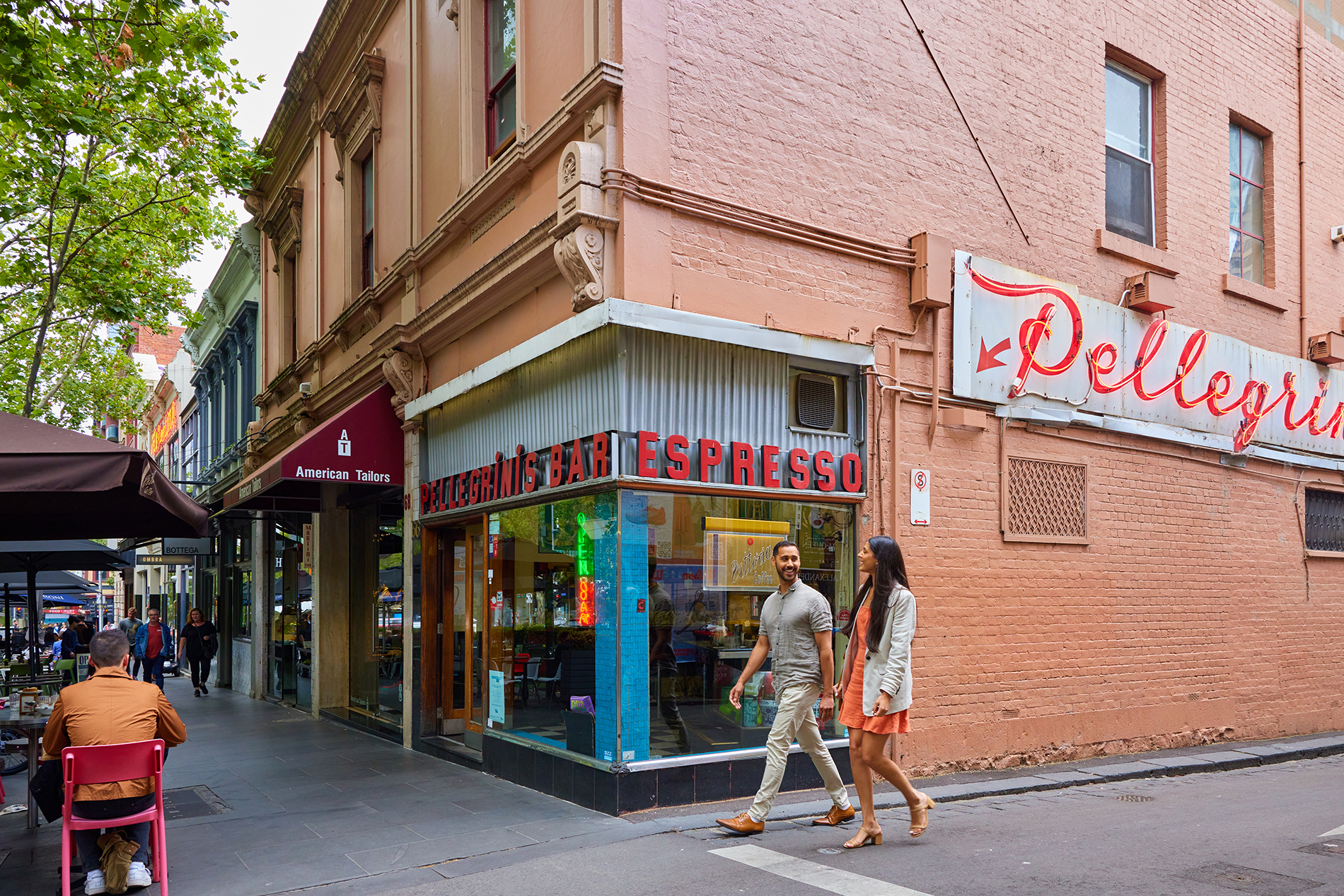 A couple walking past a restaurant