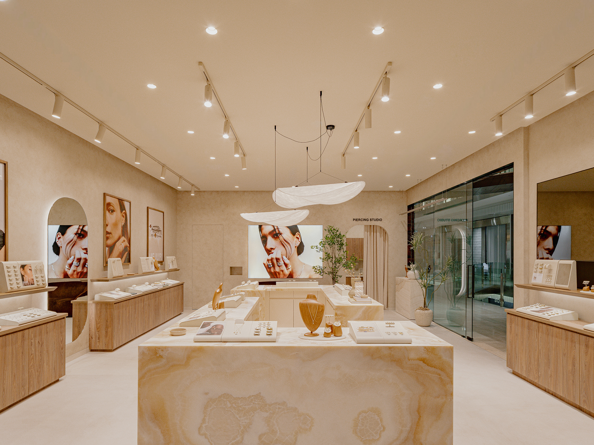 A jewellery boutique with marble displays and pendant lights.