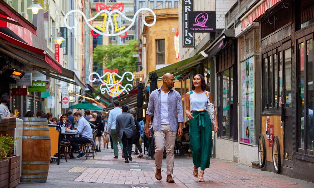 A couple walking in a laneway.