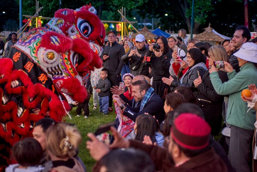 A crowd watching a dragon dance.