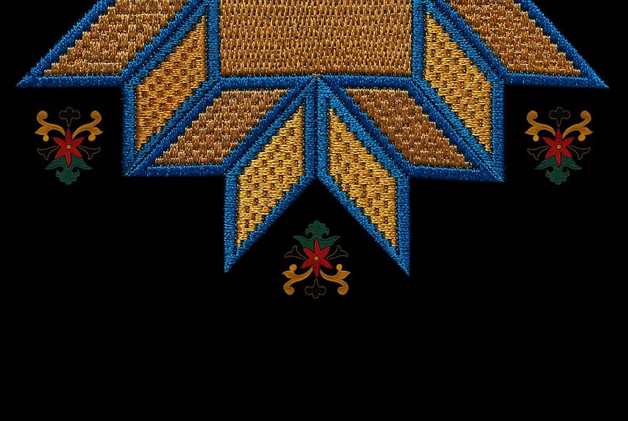 A close up of a hand embroidered handkerchief showing a yellow star with blue outline and small floral motifs on a black fabric.