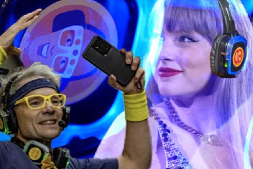 Musical walking tour leader wearing headband, headphones and yellow glasses, holding a phone with an image of Taylor Swift in the background.