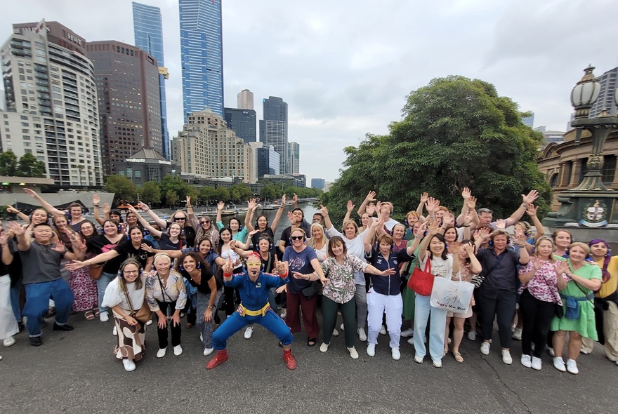 Flashmob group on a city rooftop with buildings in the background.