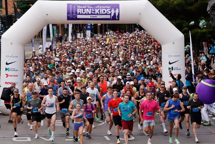 The starting line of Run for the Kids with hundreds of runners taking park. 
