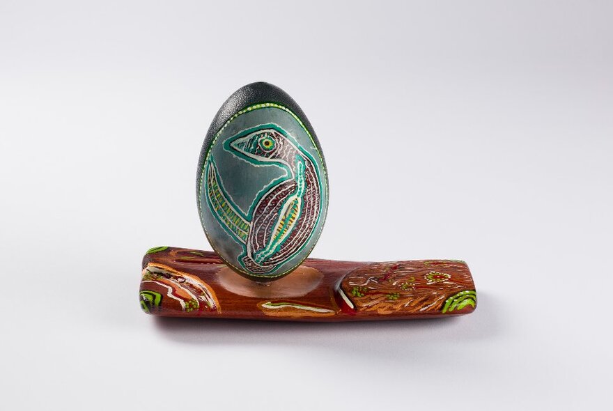 First Nationals art piece showing a decorated emu egg on a painted base.