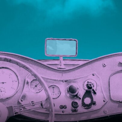 Interior dashboard and steering wheel of a vintage car, rendered in a stylised monochromatic purplish tone.