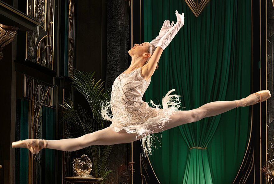 Ballet dancer wearing 1920s fringed dress performing mid-air grand jete.