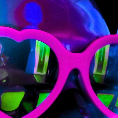 Heart-shaped sunglasses with green reflections.