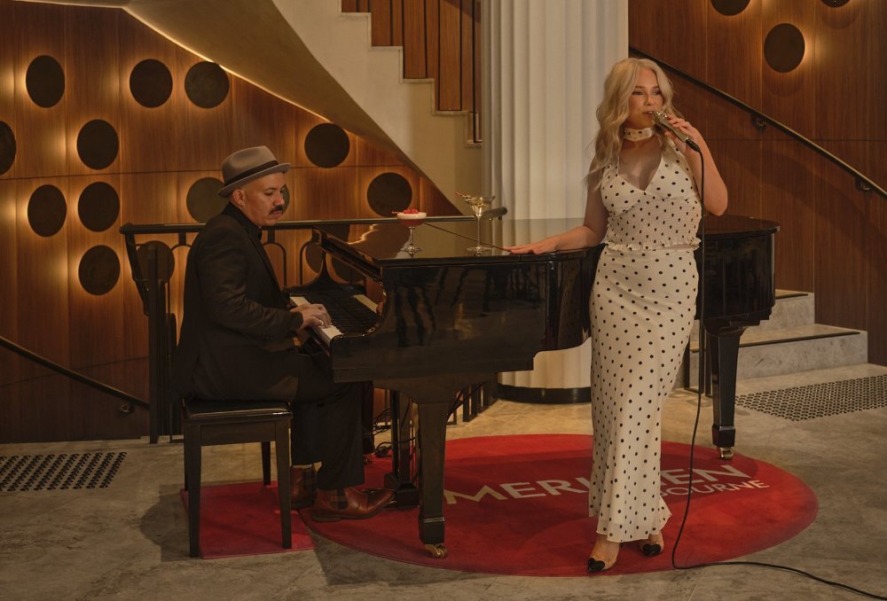 A woman singing while a man plays piano.