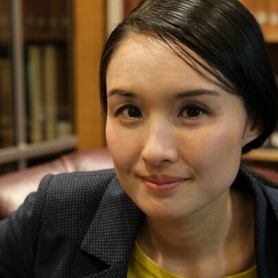 Author Alice Pung, with a slight smile, her straight dark hair is pulled back off her face.
