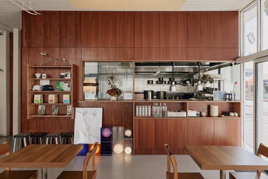 The interior of Vietnamese cafe and restaurant, Cham, with wooden cabinetry and tables.