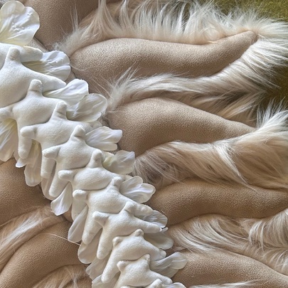 A sculptural artpiece made from fabric that represents a spine and ribs or lungs.