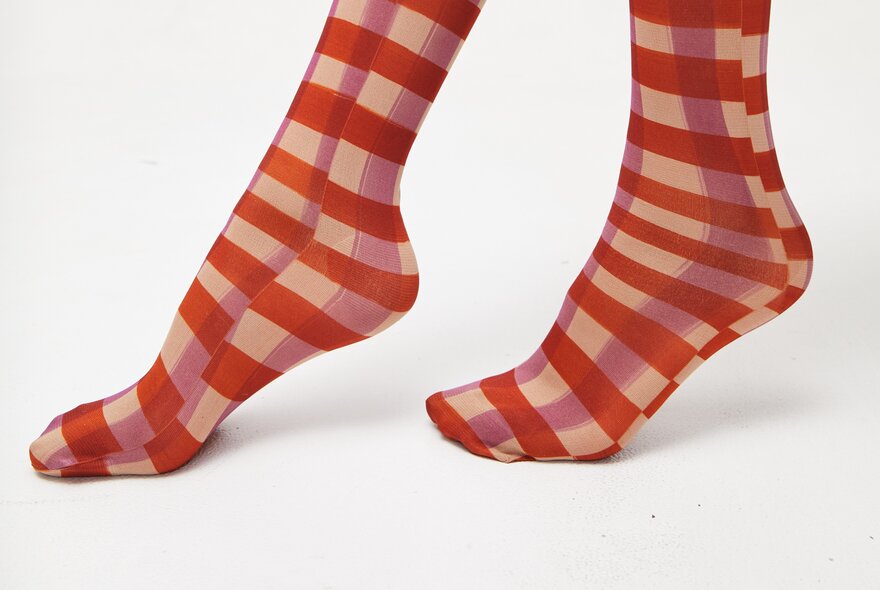 A pair of hand painted socks with a check pattern