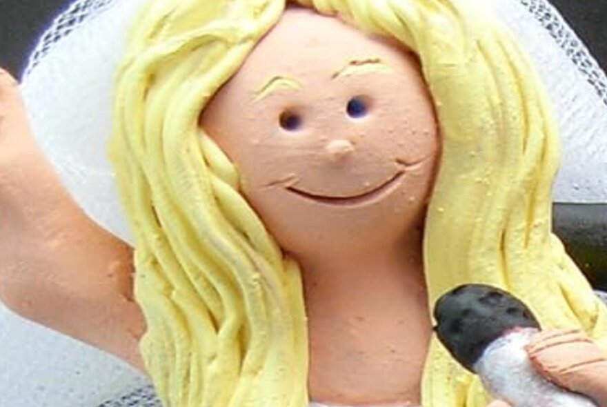 Clay figure bride with blonde hair and white veil.