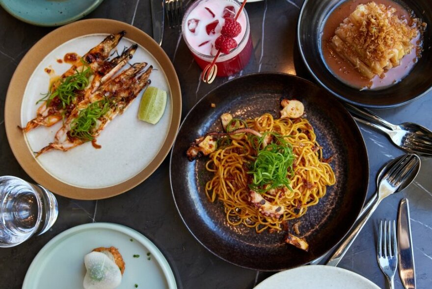 Plates of Chinese food and cocktails.