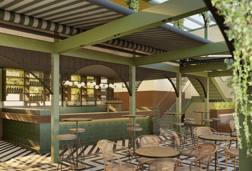 An open-air rooftop bar with a green interior, outdoor furniture and foliage.