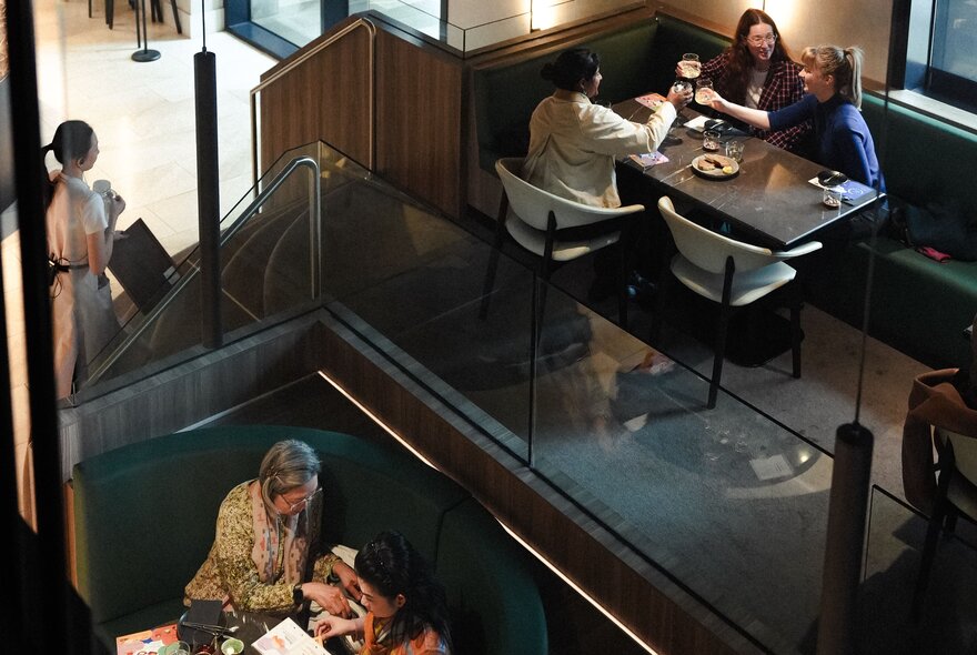 Overhead view of cafe diners seated eating at tables and booths.