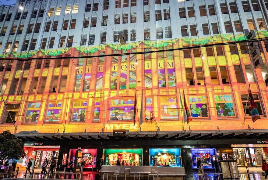 Colourful projections on a Myer building at night.