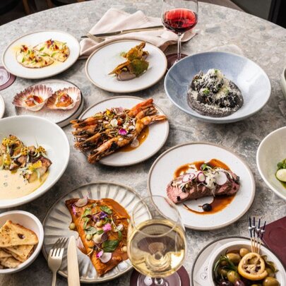 Large spread of seafood dishes including oysters.