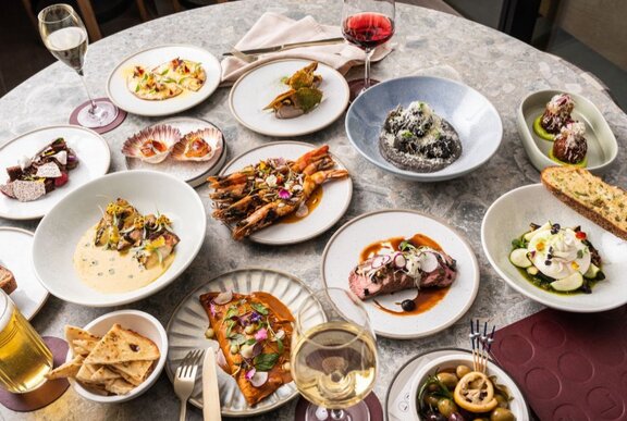 Large spread of seafood dishes including oysters.