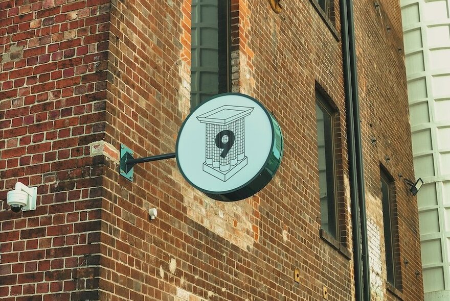 Silo No 9 signage on an old brick tower wall.