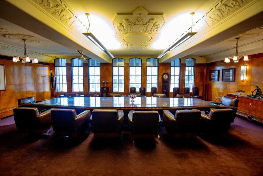 A long boardroom table in an old-fashioned meeting room.