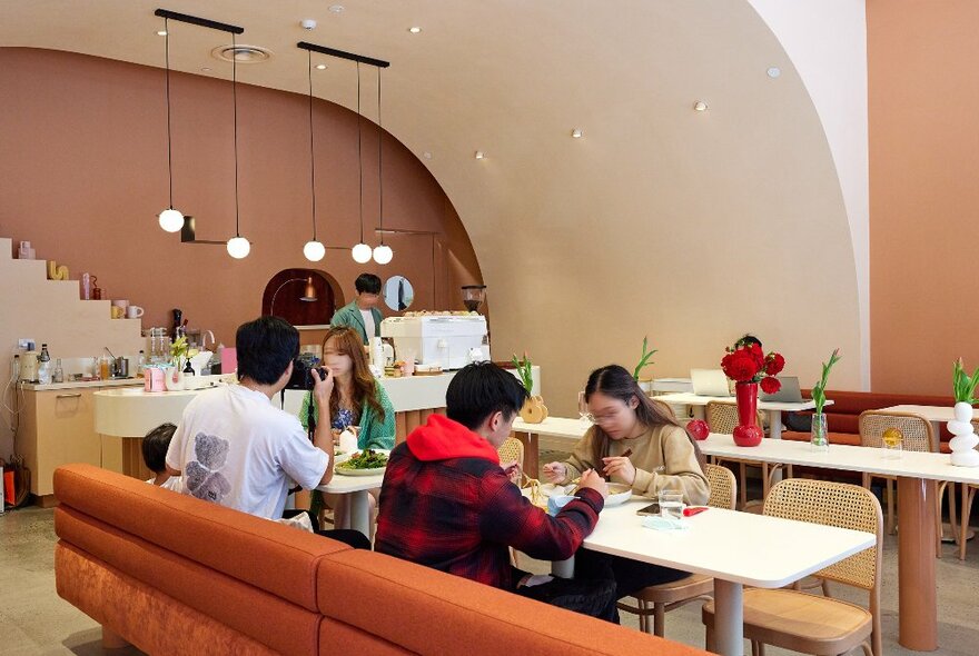 A group of people are sitting in a cafe eating brunch