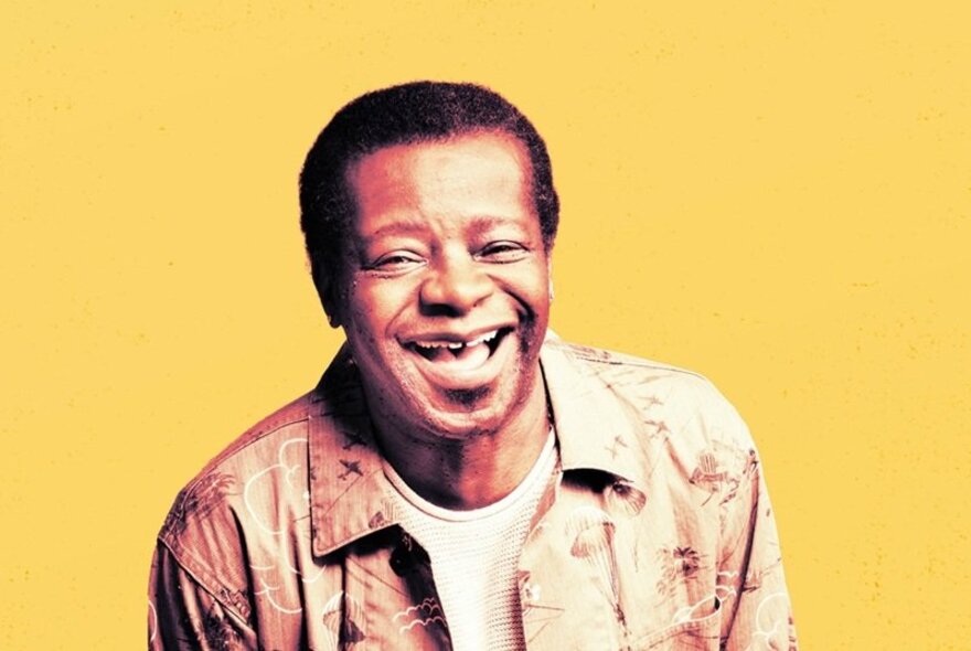 Comedian Stephen K Amos, laughing with eyes shut.