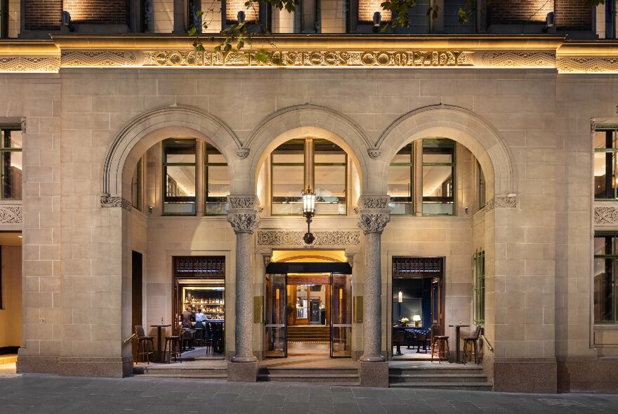 The illuminated exterior of the Douglas Club, showing its classical architecture.