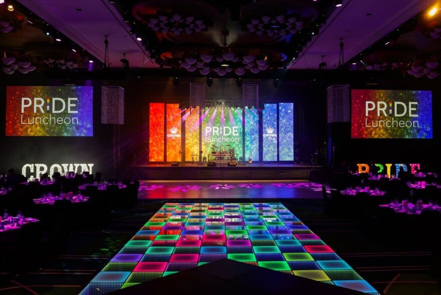 A rainbow lit stage and chequered lit runway.