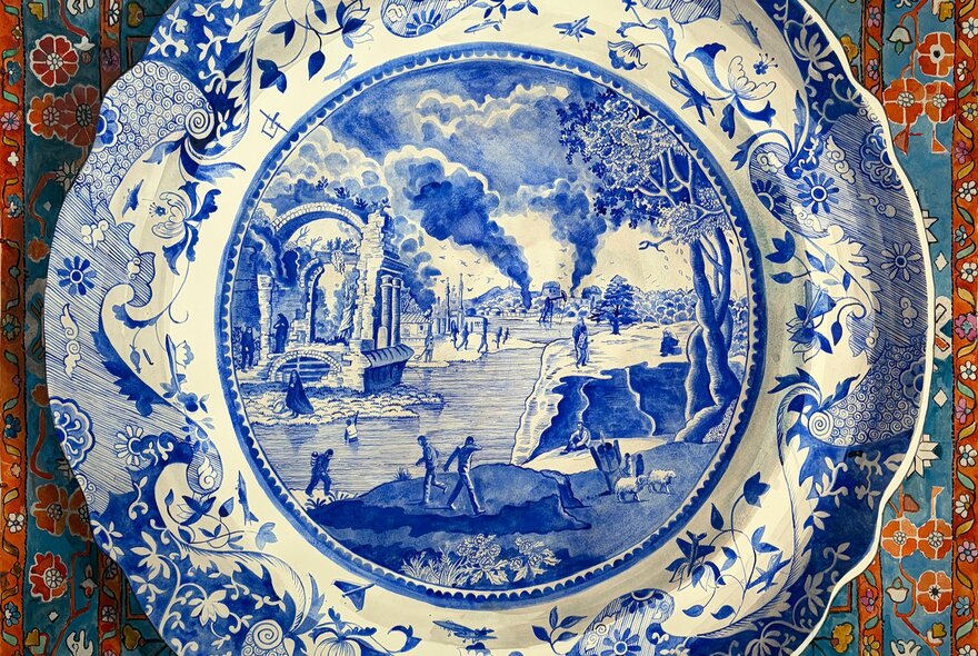 A delicately painted porcelain plate with a blue design depicting waves around the outside and a burning landscape in the centre.