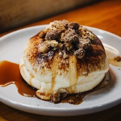 A fluffy souffle pancake stack, with a caramel topping.