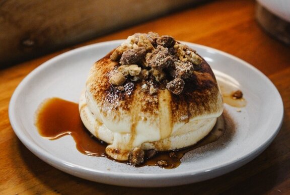 A fluffy souffle pancake stack, with a caramel topping.
