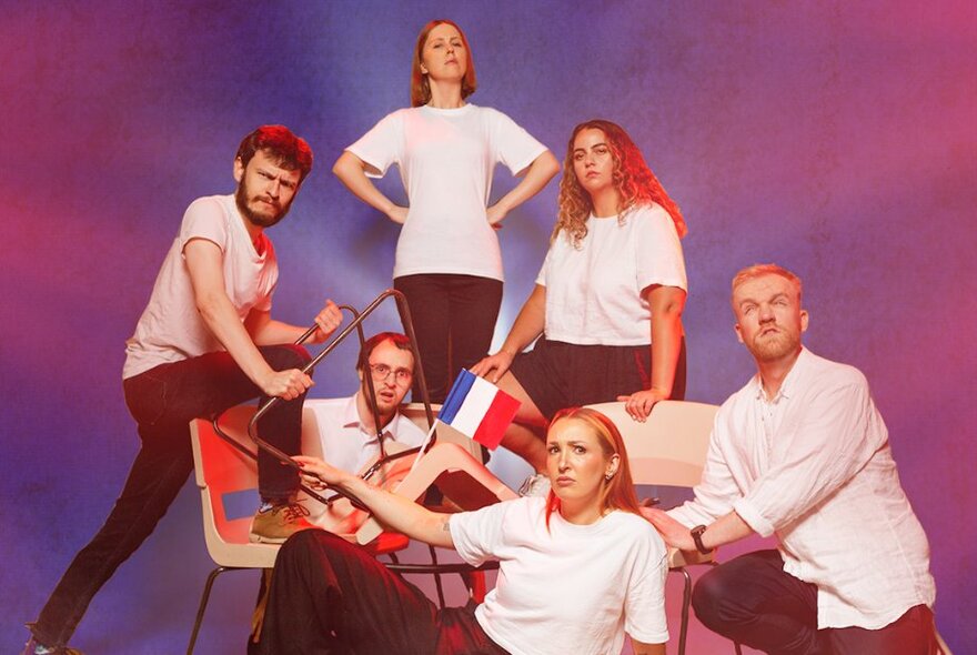 Performers from the impro group Les Improvisé, standing or seated and posed for the camera.