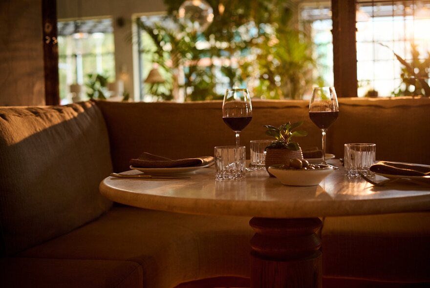 A table set for dinner, with comfortable banquette seating.