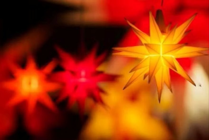 Hanging and glowing Christmas 3D star decorations.