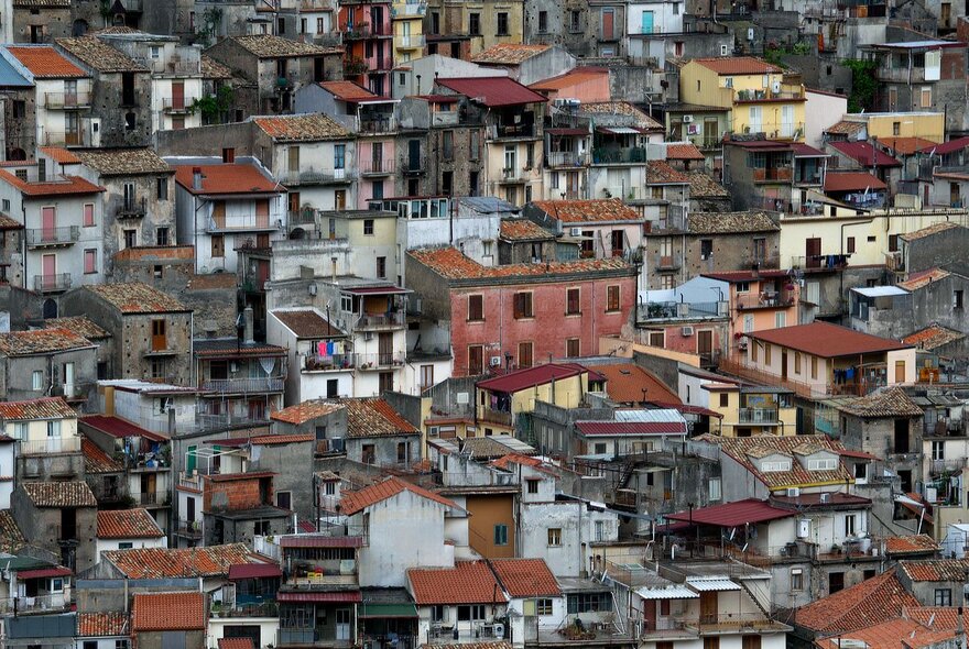 Photograph of urban dwellings in Italy with terracotta coloured roofs.