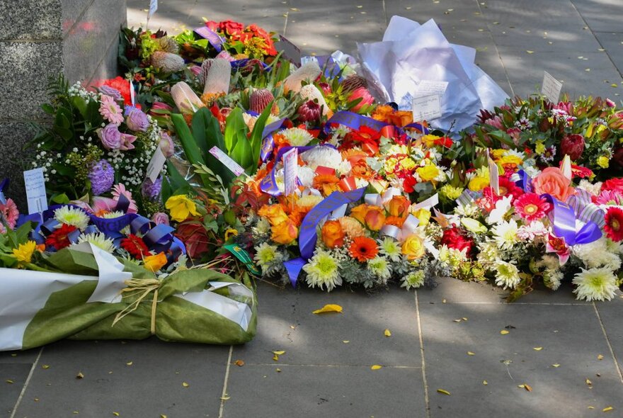 Wreaths and bouquets on street, placed in memorium.