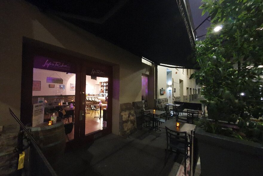 Dark bar terrace with outdoor seating.