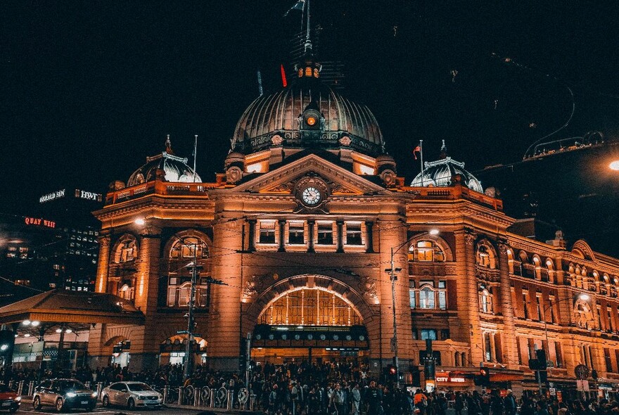 Flinders Street Station illuminated at night.