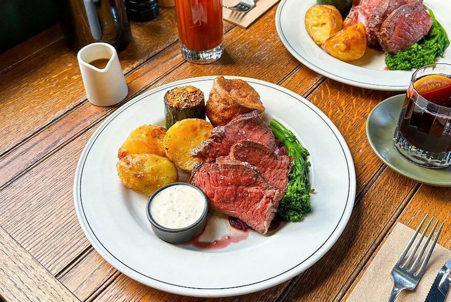 A roast meal with potatoes, meat and yorkshire pudding