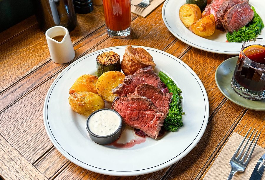 A roast meal with potatoes, meat and yorkshire pudding