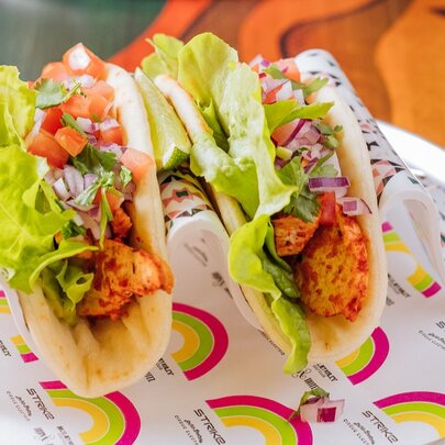 Two tacos on a plate.