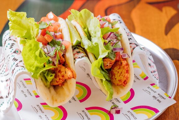 Two tacos on a plate.